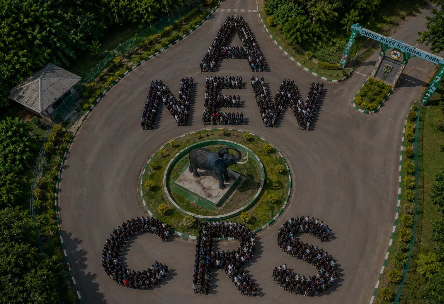Crowd forming the words A NEW CRS around the elephant at Cross River National Park